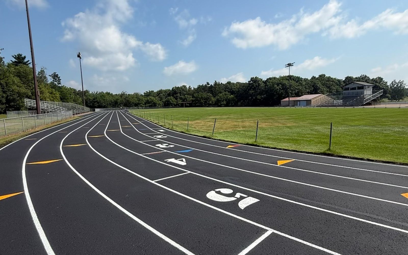 Resurfaced running track with measured lanes and numbers